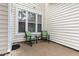 Cozy patio with white siding, large window, and seating, perfect for enjoying the outdoors at 2314 Wispy Green Ln, Raleigh, NC 27614