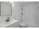 Updated bathroom with sleek vanity and modern tile in shower at 2506 Dominion St, Durham, NC 27704