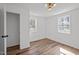 Inviting bedroom with hardwood floors, white walls, two windows and modern lighting at 2506 Dominion St, Durham, NC 27704