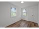 Light-filled bedroom with two windows and wood-look floors at 2506 Dominion St, Durham, NC 27704