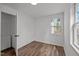 Bedroom with wood-look floors, closet and window view at 2506 Dominion St, Durham, NC 27704