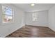 This bedroom has wood floors, two windows and white walls at 2506 Dominion St, Durham, NC 27704