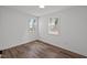 Bedroom with wood-look floors and natural light from two windows at 2506 Dominion St, Durham, NC 27704