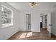 Light-filled bedroom with wood-look floors and bathroom access at 2506 Dominion St, Durham, NC 27704