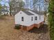 An exterior shot of a home with white siding, and a dark roof at 2506 Dominion St, Durham, NC 27704