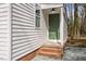 Inviting front entrance with green door, red brick steps, and contemporary lighting at 2506 Dominion St, Durham, NC 27704