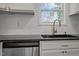 Updated kitchen showcasing stainless steel dishwasher, granite countertops and stylish hardware at 2506 Dominion St, Durham, NC 27704