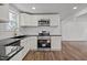 Well-appointed kitchen with stainless steel appliances, granite counters, and hardwood floors at 2506 Dominion St, Durham, NC 27704
