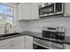 Modern kitchen with stainless steel appliances, sleek countertops, and ample cabinet space at 2506 Dominion St, Durham, NC 27704