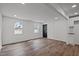 Open-concept living area with hardwood flooring, white walls, and modern lighting at 2506 Dominion St, Durham, NC 27704