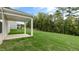 The backyard features mature trees, grass and a covered patio off the back of the home at 269 Umstead St, Sanford, NC 27330