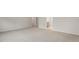 Open basement featuring neutral carpet and white trim, with views into a bathroom at 269 Umstead St, Sanford, NC 27330