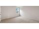 Neutral carpeted bedroom featuring white trim, walls, and a window offering natural light at 269 Umstead St, Sanford, NC 27330