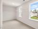 Bright bedroom featuring neutral carpet, white walls, and closet with shelving at 269 Umstead St, Sanford, NC 27330