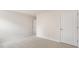 A clean and bright bedroom with neutral carpet and paint and two doors at 269 Umstead St, Sanford, NC 27330