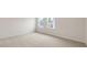 Bright bedroom featuring neutral carpet, white walls, and double windows offering natural light at 269 Umstead St, Sanford, NC 27330