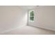 Bright bedroom featuring neutral carpet, large window, and white trim at 269 Umstead St, Sanford, NC 27330