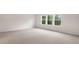 Neutral carpeted bedroom with bright windows offering natural light and views of the outdoors at 269 Umstead St, Sanford, NC 27330