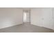 Neutral carpeted bedroom featuring white trim, walls, and a glimpse into the hallway at 269 Umstead St, Sanford, NC 27330