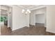 Open concept dining room with modern chandelier, hardwood floors, and access to kitchen at 269 Umstead St, Sanford, NC 27330