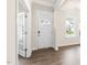 Bright entryway with hardwood floors, white trim, and glass paned french doors on left at 269 Umstead St, Sanford, NC 27330