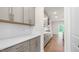 Gourmet kitchen featuring white countertops, gray cabinets, subway tile backsplash, and stainless steel appliances at 269 Umstead St, Sanford, NC 27330