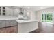 Open kitchen with stainless steel appliances, a large island, and sliding doors to the outdoor area at 269 Umstead St, Sanford, NC 27330