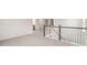 Carpeted loft with stair rail and access to rooms at 269 Umstead St, Sanford, NC 27330