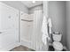 Bathroom featuring a shower with white tiling, a white shower curtain, and a toilet at 2912 Oakley Woods Ln, Apex, NC 27539