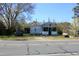 Modest single-story home with a small front porch and a car parked on the front lawn at 2984 Ashe Ave, Dunn, NC 28334
