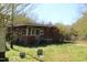 Exterior shot of the red outbuilding and grassy yard at 2984 Ashe Ave, Dunn, NC 28334