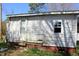Close-up of the side of the house showing white siding, a door, and a window at 2984 Ashe Ave, Dunn, NC 28334