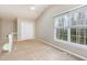 Bright bedroom with a large window, ceiling fan, and spacious closet for organized storage at 3101 Rutledge Ct, Raleigh, NC 27613