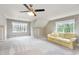 A bright bonus room with a comfortable sofa and multiple windows offering natural light at 3101 Rutledge Ct, Raleigh, NC 27613