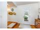 Welcoming foyer featuring hardwood floors, front door with transoms and decorative mirror at 3101 Rutledge Ct, Raleigh, NC 27613