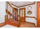 Cozy foyer featuring hardwood floors, wooden staircase, and decorative mirrors at 3101 Rutledge Ct, Raleigh, NC 27613