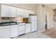 Compact kitchen equipped with essential appliances and ample cabinet space for storage at 3101 Rutledge Ct, Raleigh, NC 27613