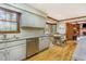 Well-lit kitchen features stainless steel appliances, wooden floors and a spacious dining area at 3101 Rutledge Ct, Raleigh, NC 27613