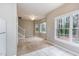 Bright living room with large windows, carpet flooring, and views of the surrounding trees at 3101 Rutledge Ct, Raleigh, NC 27613