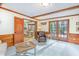 Open living room showcasing wood accents, a doorway to the kitchen, and access to an outdoor patio at 3101 Rutledge Ct, Raleigh, NC 27613