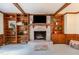 Cozy living room featuring brick fireplace with built-in bookshelves and wood accents at 3101 Rutledge Ct, Raleigh, NC 27613
