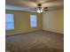 Spacious bedroom with carpet, ceiling fan with lights, and two windows with blinds at 316 Arbor Greene Dr, Garner, NC 27529