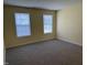 Bedroom with neutral carpet, light-colored walls, and two windows with blinds at 316 Arbor Greene Dr, Garner, NC 27529