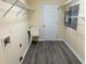 Well lit laundry room has shelving and a utility sink at 316 Arbor Greene Dr, Garner, NC 27529