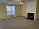 Living room with neutral carpet and a cozy fireplace at 316 Arbor Greene Dr, Garner, NC 27529