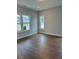 Cozy bedroom with hardwood floors and abundant natural light from large windows at 321 Kavanaugh Rd, Wake Forest, NC 27587