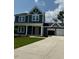 Charming two-story home with a covered front porch, well-manicured lawn, and two car garage at 321 Kavanaugh Rd, Wake Forest, NC 27587