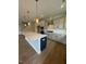 Modern kitchen featuring gray cabinets, stainless steel appliances, a large island, and hardwood floors at 321 Kavanaugh Rd, Wake Forest, NC 27587