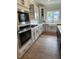 Beautiful kitchen showcasing stainless steel appliances, a farmhouse sink, and ample cabinet space at 321 Kavanaugh Rd, Wake Forest, NC 27587