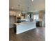Bright, modern kitchen featuring a large island, stainless steel appliances, and stylish pendant lighting at 321 Kavanaugh Rd, Wake Forest, NC 27587